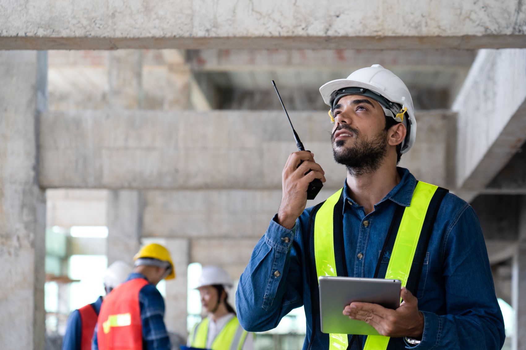 man using Motorola two-way radio at Philadelphia construction site