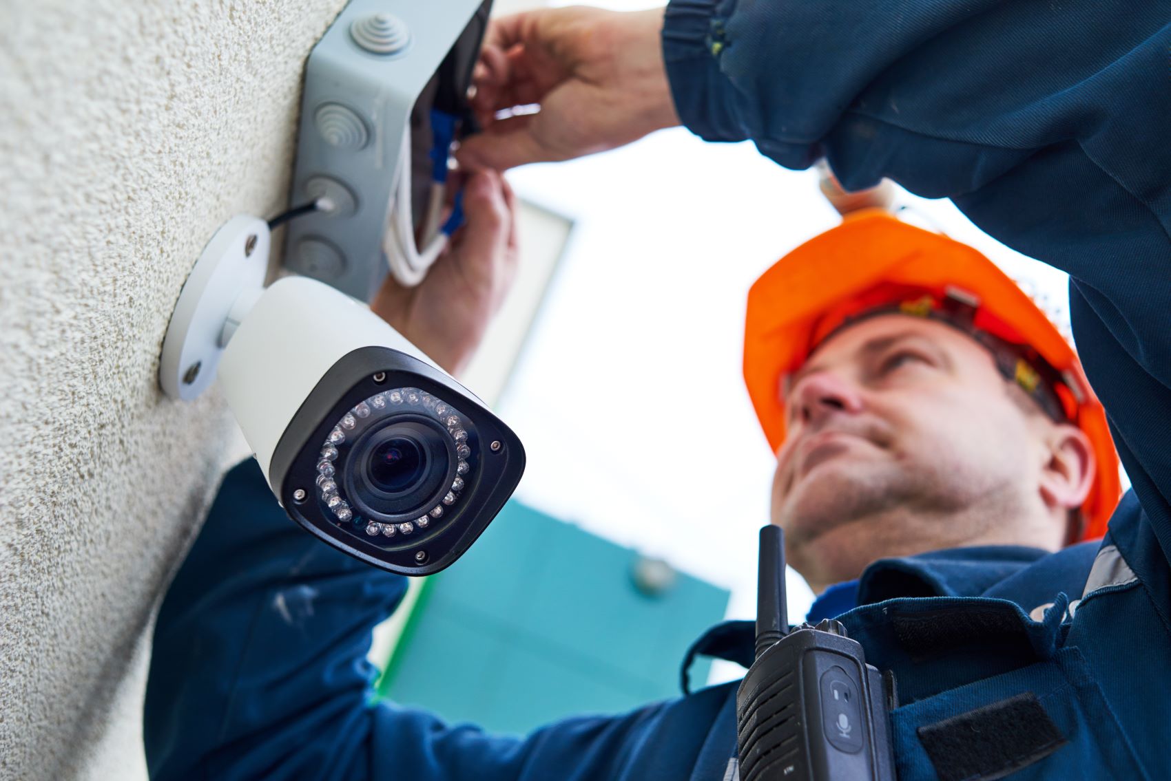 person installing surveillance camera 