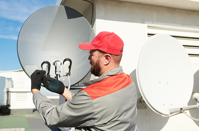 man working on satellite dish