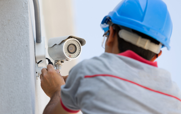 man checking security camera