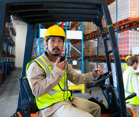 man on radio driving forklift